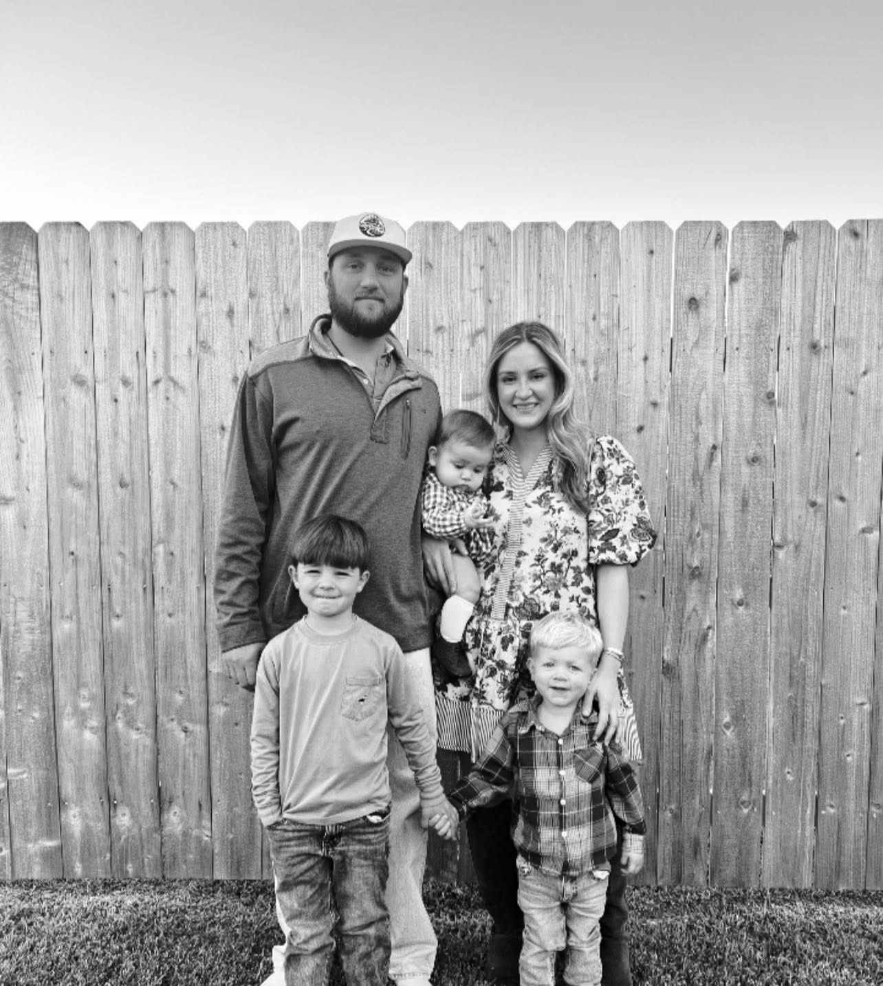 The Domingues family standing together in a backyard